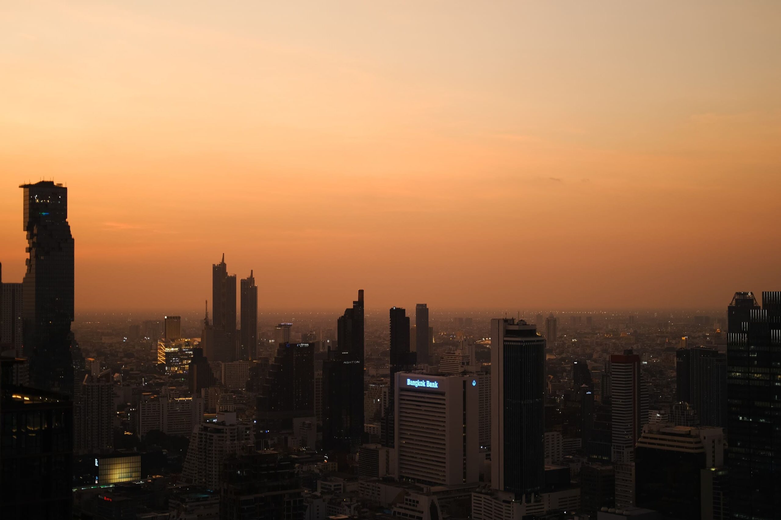 aerial view of bangkok city by sunset with rising skyscrapers