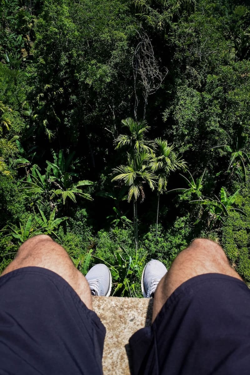 sitting on the Nine Arch Bridge surrounded by jungle in Ella Sri Lanka