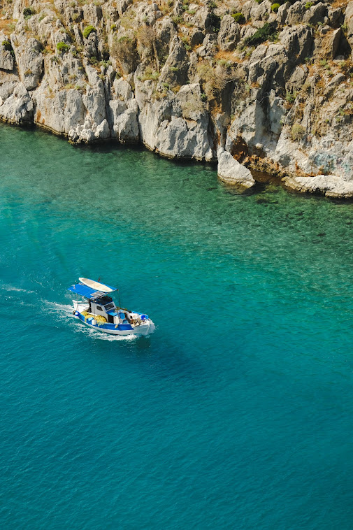 traditional fishing boat in the turquoise waters in kalymnos greece
